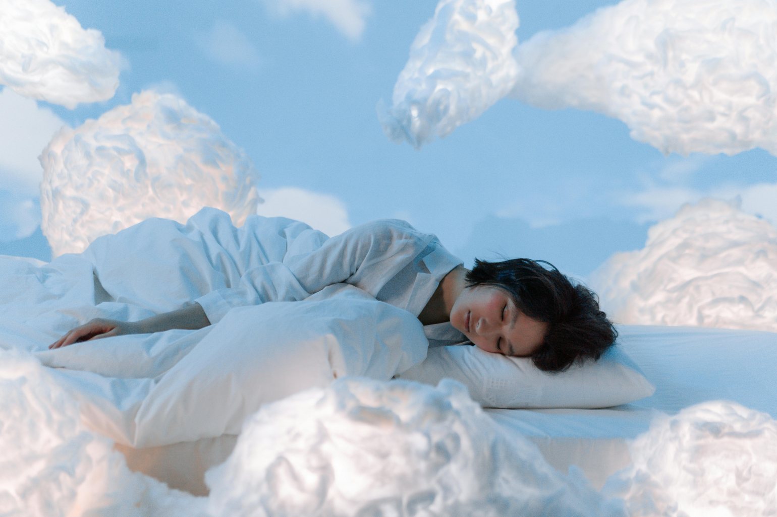 Woman sleeping on clouds